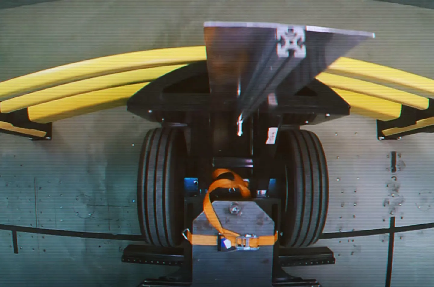 Impact test showing a vehicle colliding with polymer barrier protection in a controlled environment