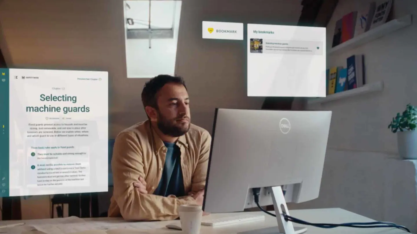 Working with the Axelent Safety Book Man looking at a computer