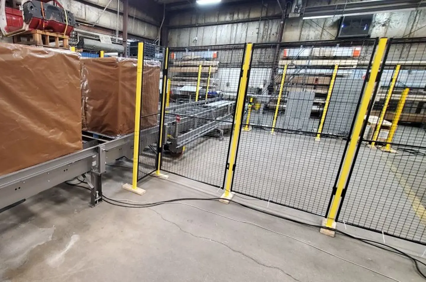 fencing protecting conveyor with boxes