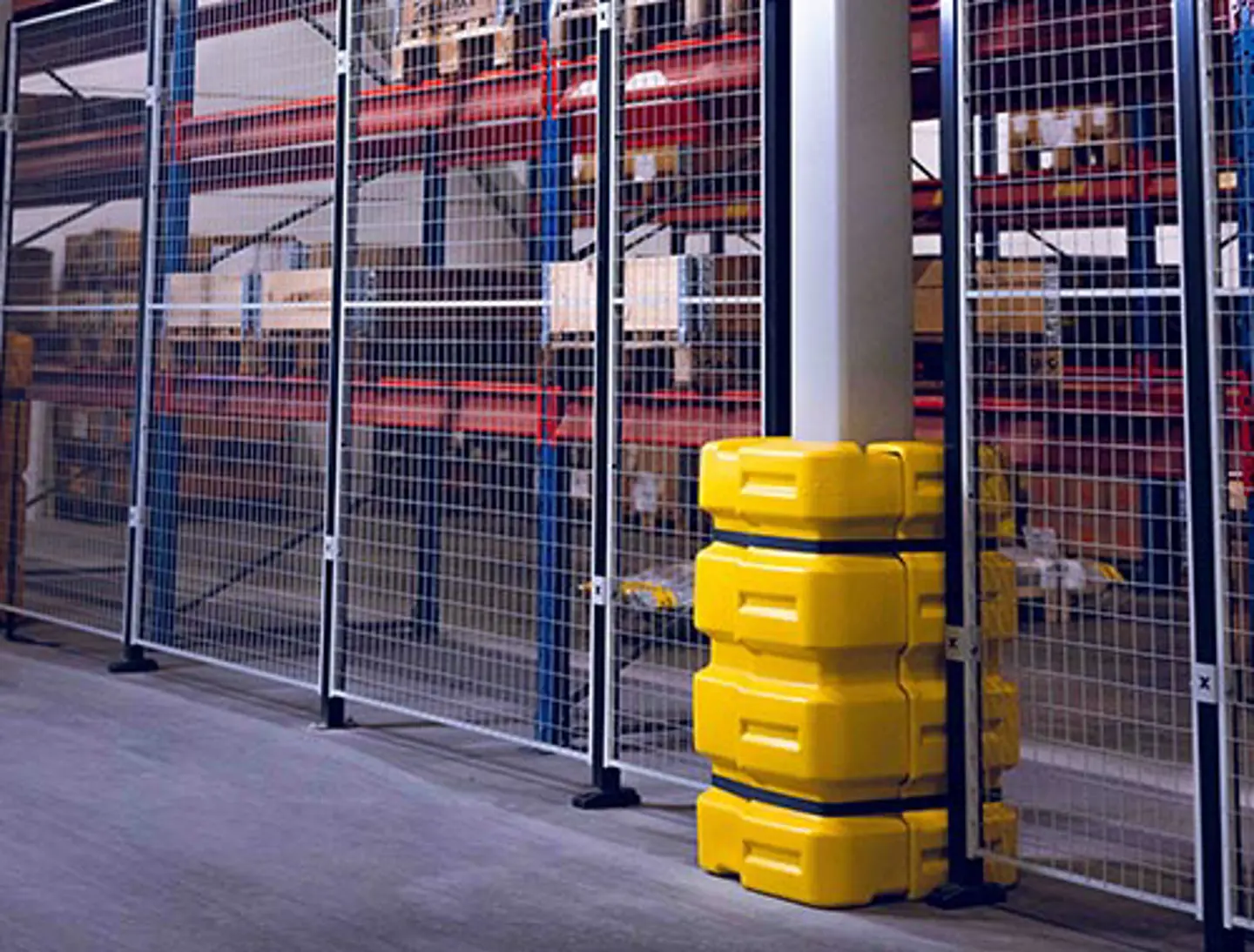 a yellow bollard protecting a pillar in a warehouse