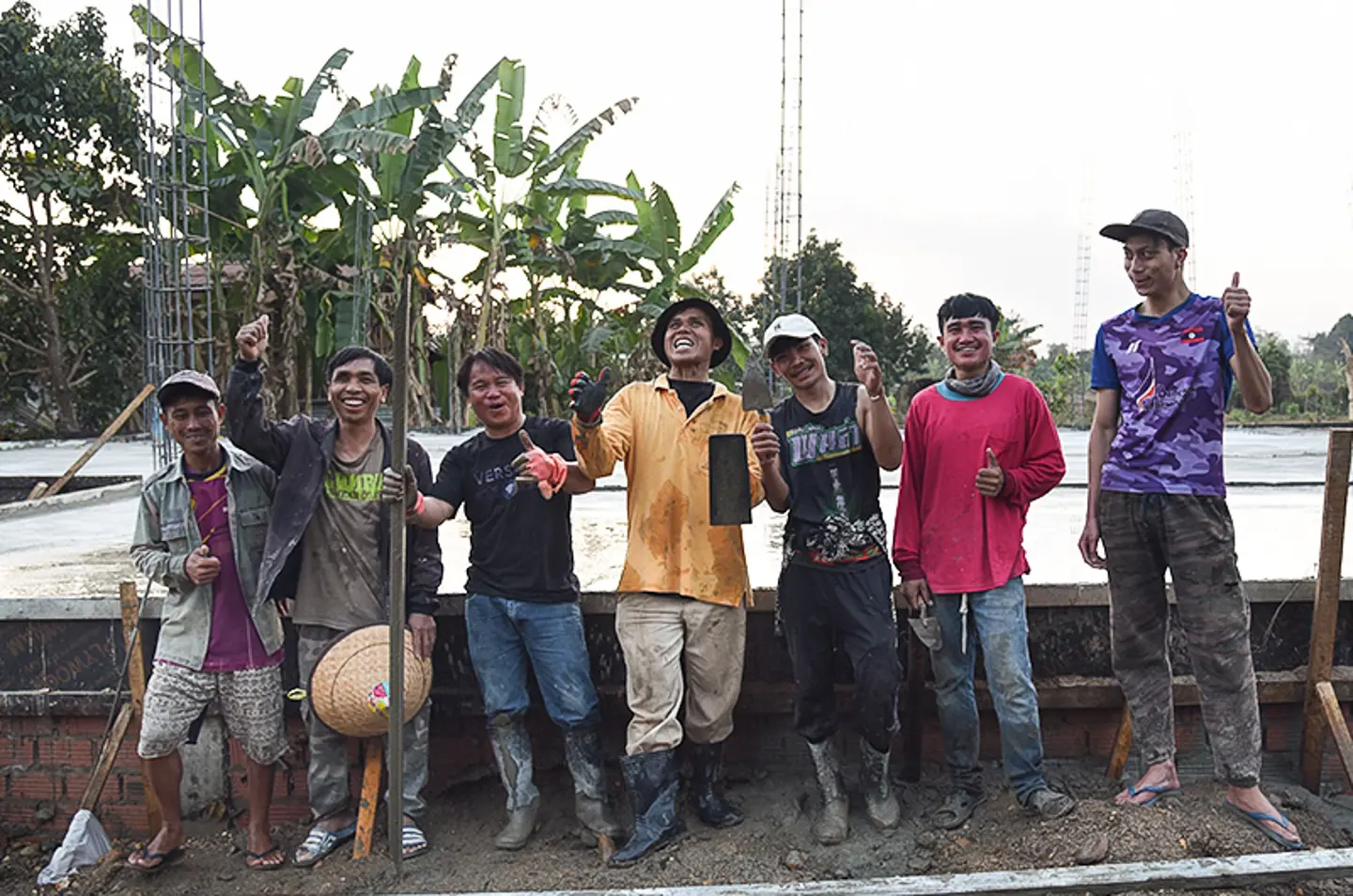 Construction workers standing in front of the new building at Touk för Livet’s family home in Laos.